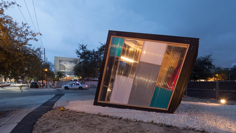 Modern building with transparent walls and colorful interior at night