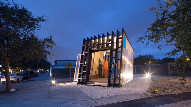 Dark building with angular design and lit windows at night