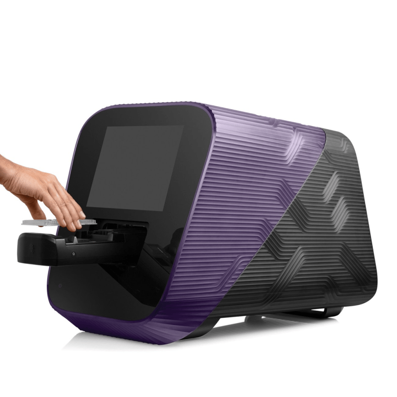 Purple and black electronic device on a white surface with hands interacting