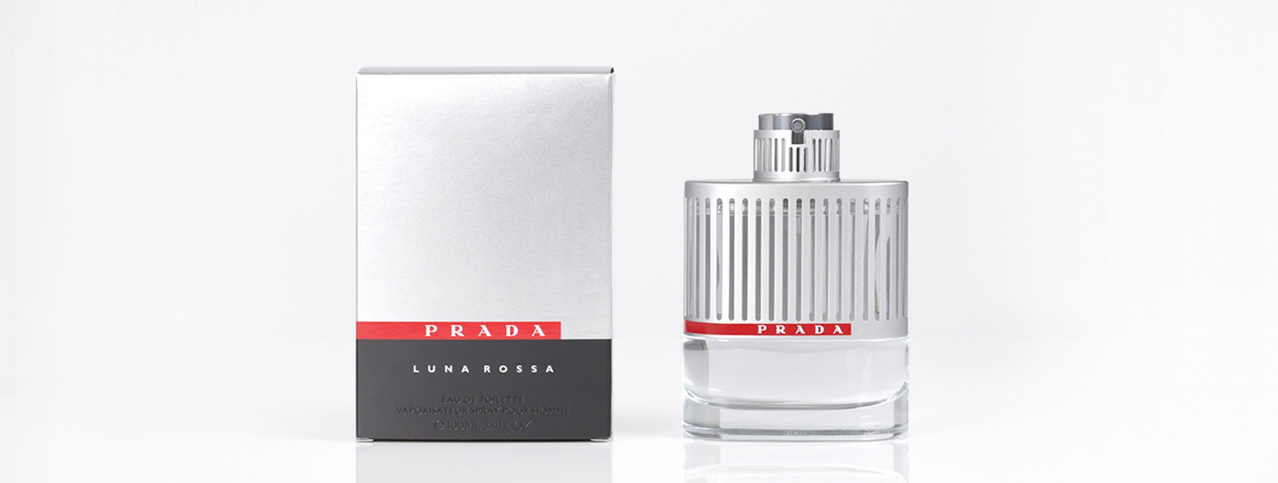 Three skincare bottles with silver caps and red/black labels on a white background