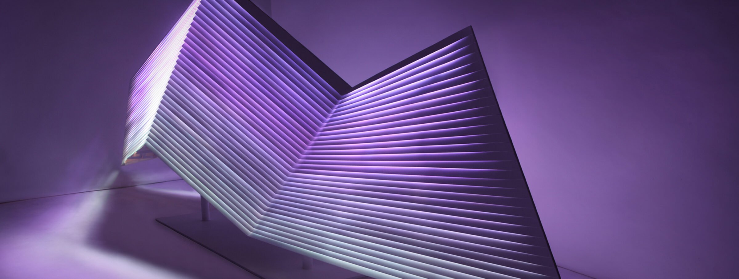 Purple and navy abstract sculpture with geometric shapes