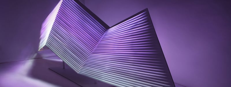 Purple and navy abstract sculpture with geometric shapes