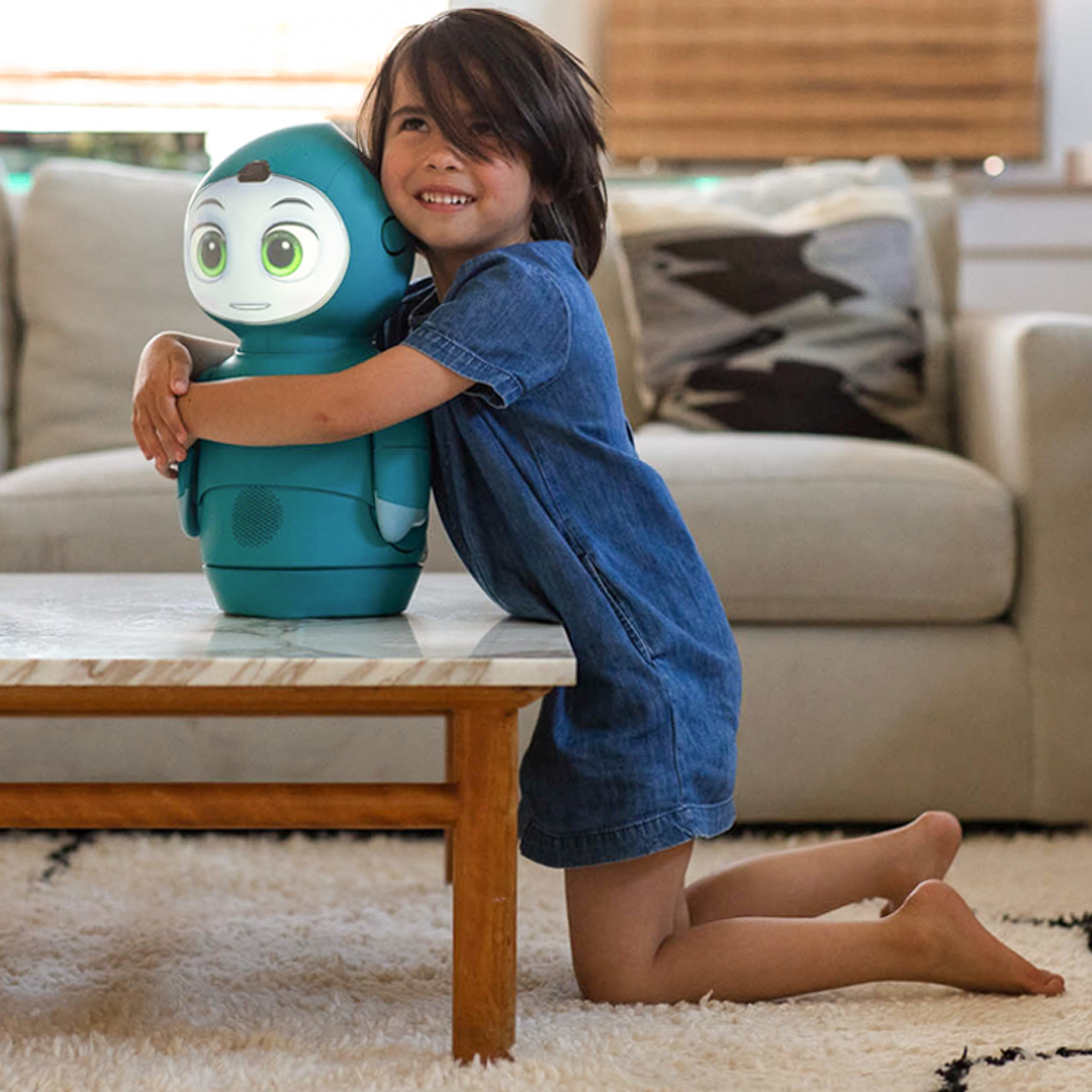 Child interacting with Moxie social robot