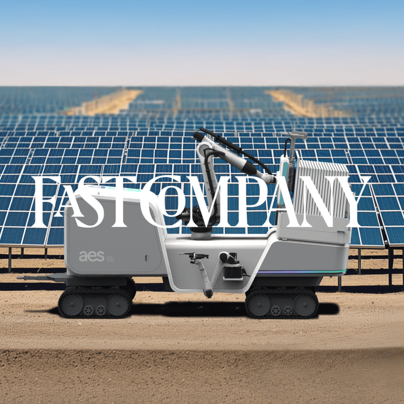 Electric vehicle with 'FAST COMPANY' text parked in front of solar farm