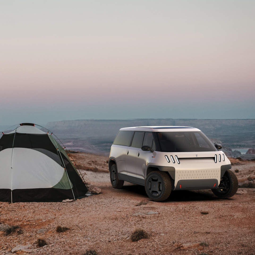 Futuristic electric vehicle parked in desert environment