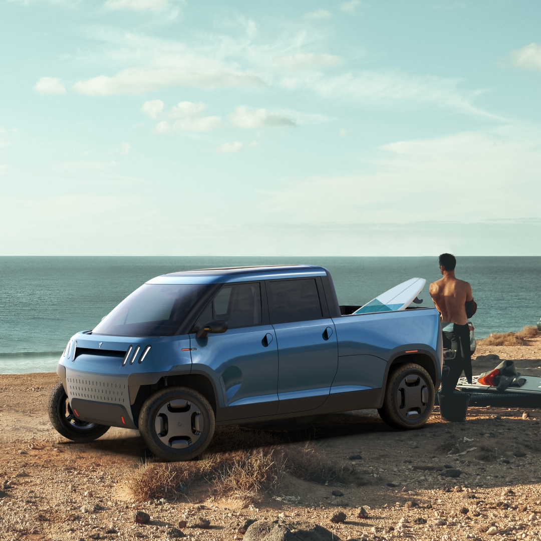 TELO blue electric truck parked on sandy beach