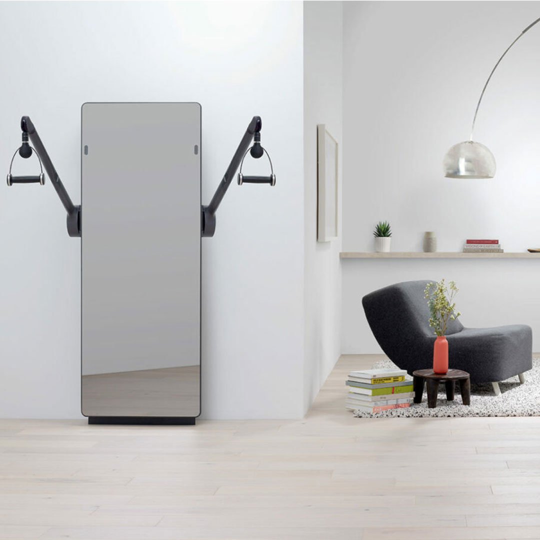 Minimalist living room with gray sofa, white rug, and black floor lamp