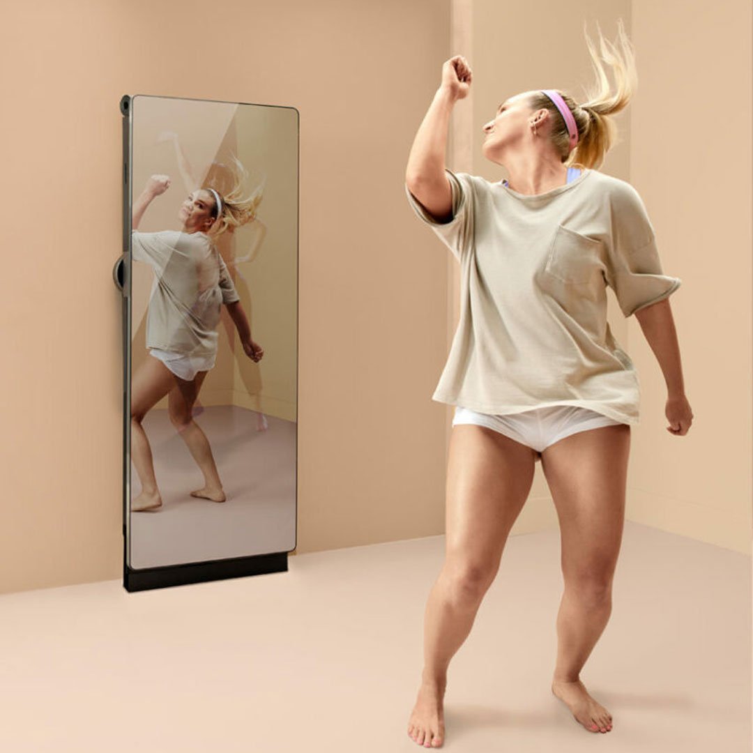 Woman and person in white tank tops and shorts, indoors