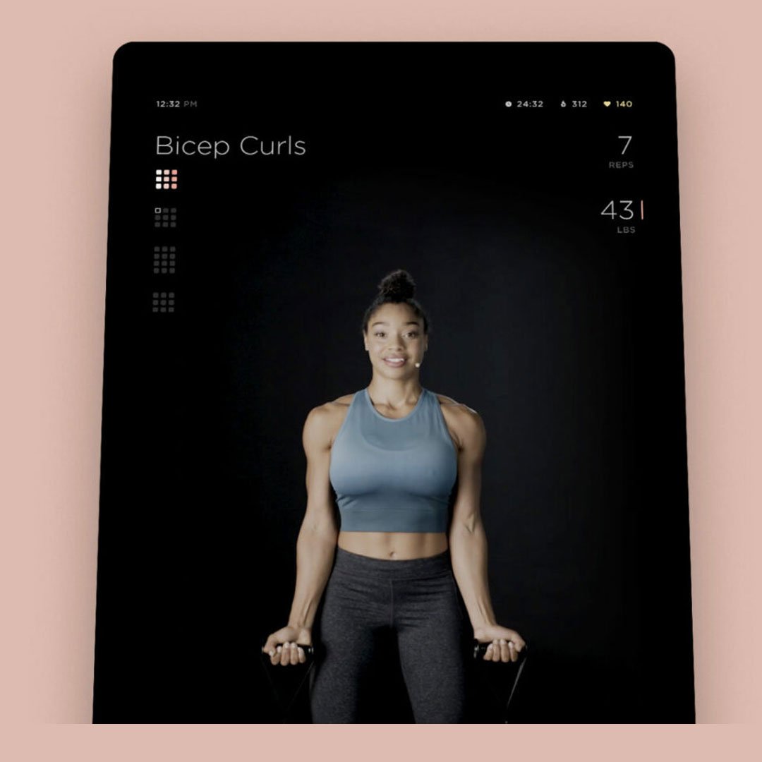 Woman in sports bra and leggings on a fitness app screen