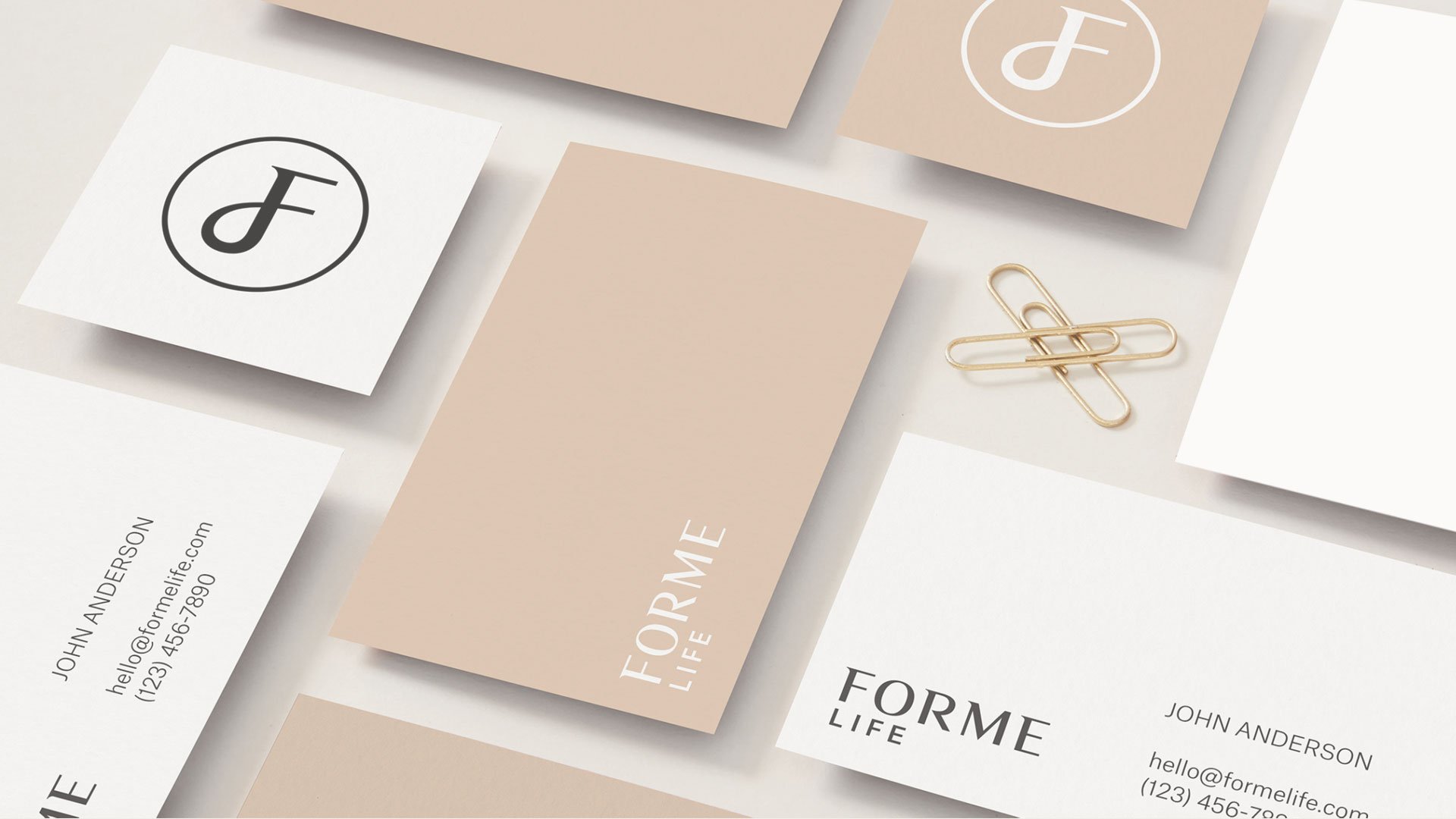 Business cards and tags on a light background with gold accents