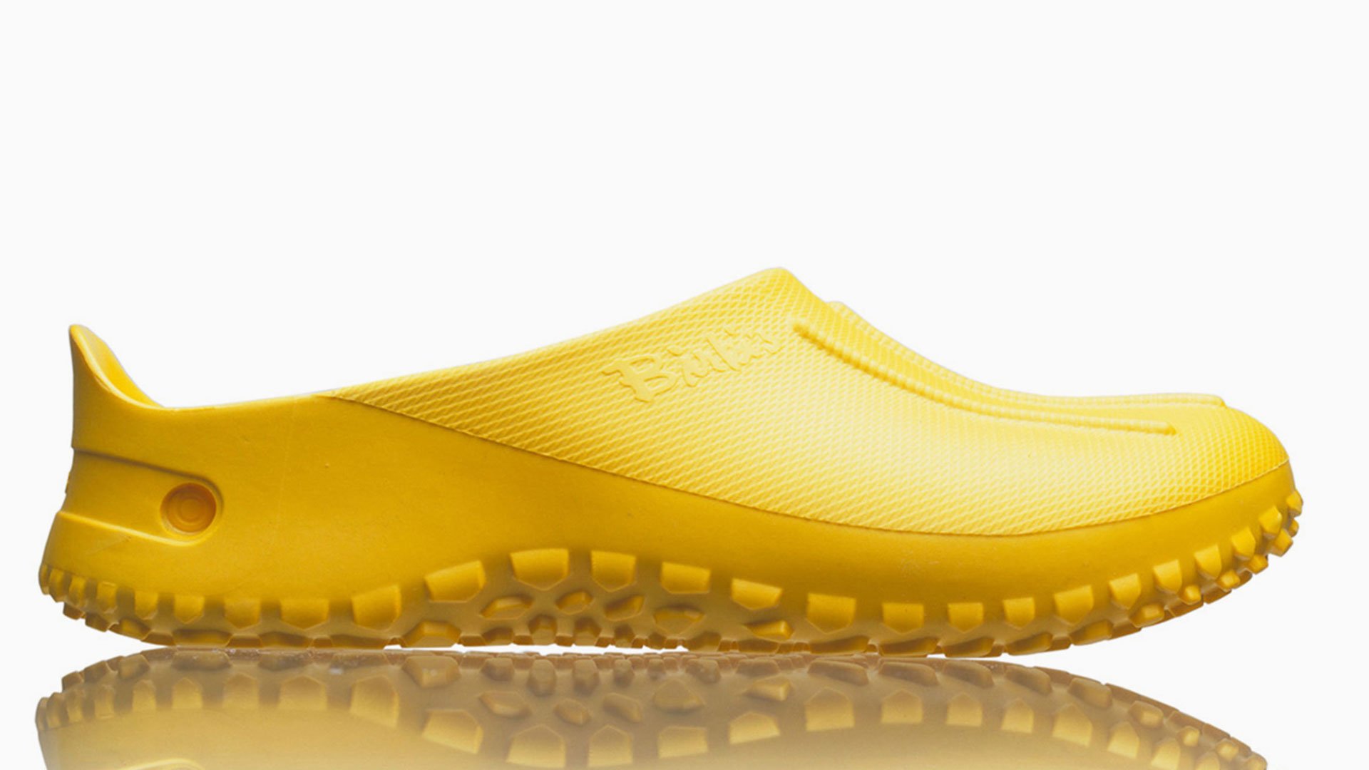 Yellow shoes with textured sole on a white background