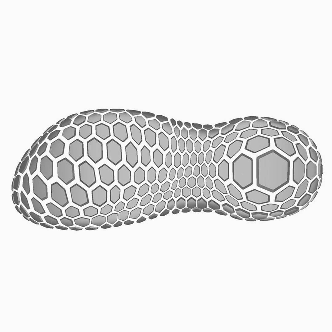 Gray shoe with hexagon and circle pattern next to a honeycomb model