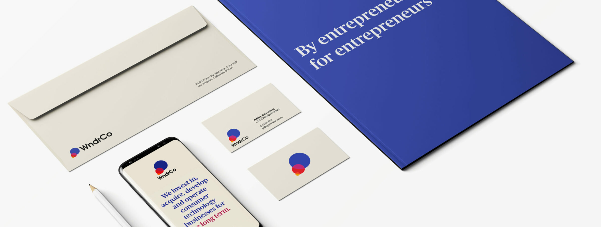 WndrCo brand identity layout featuring envelope, business cards, smartphone mockup and blue By entrepreneurs for entrepreneur