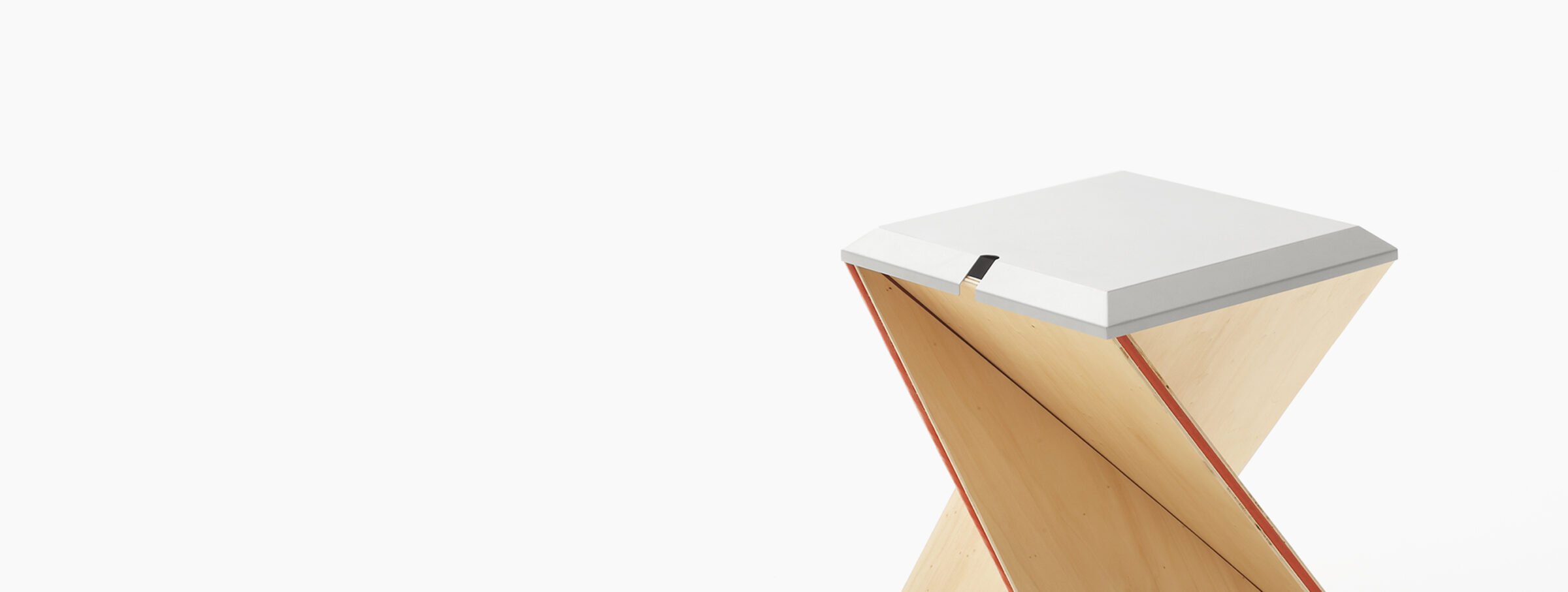 Wooden desk with sloped top and red stripe on a plain background