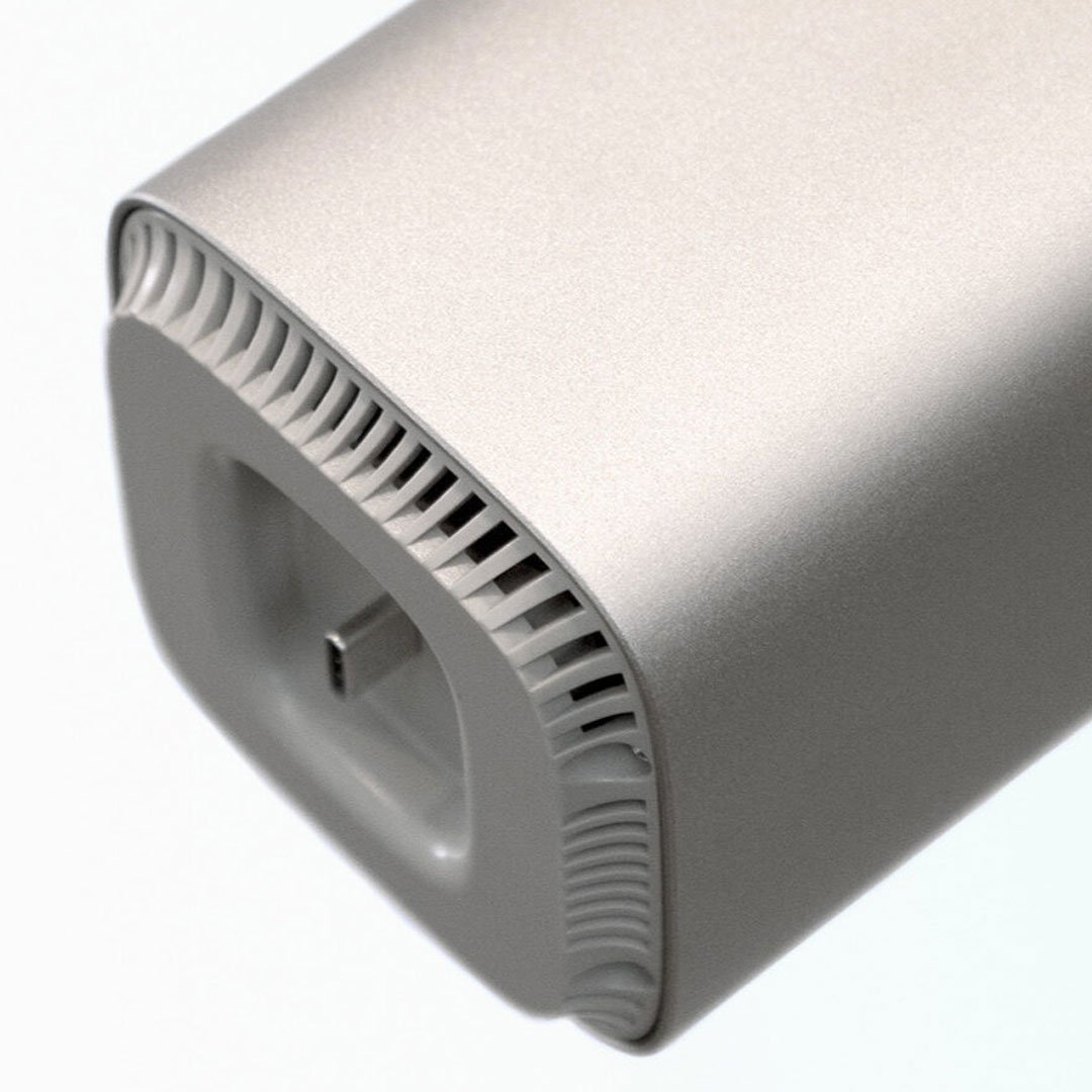 Functionland sleek metallic electronic appliance with ventilation grille on neutral background