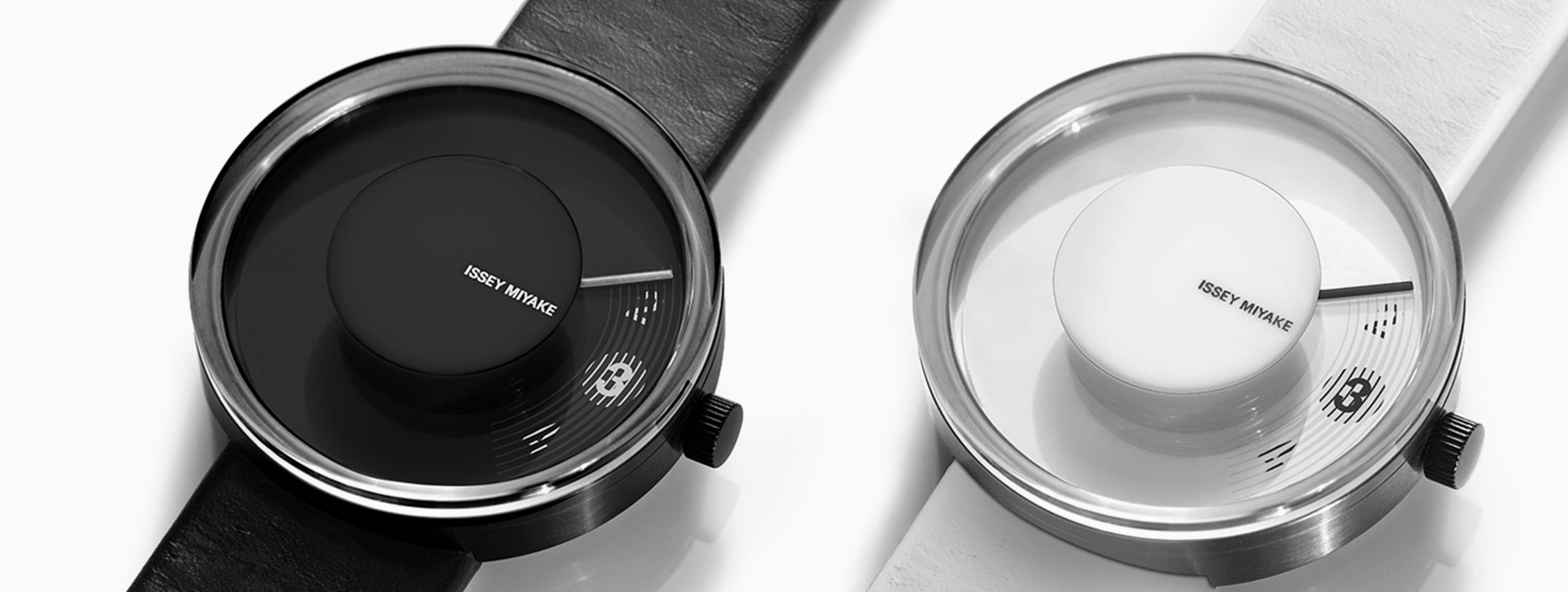 Issey Miyake V watch by fuseproject shown in black and white-silver editions with minimalist dial and leather strap.