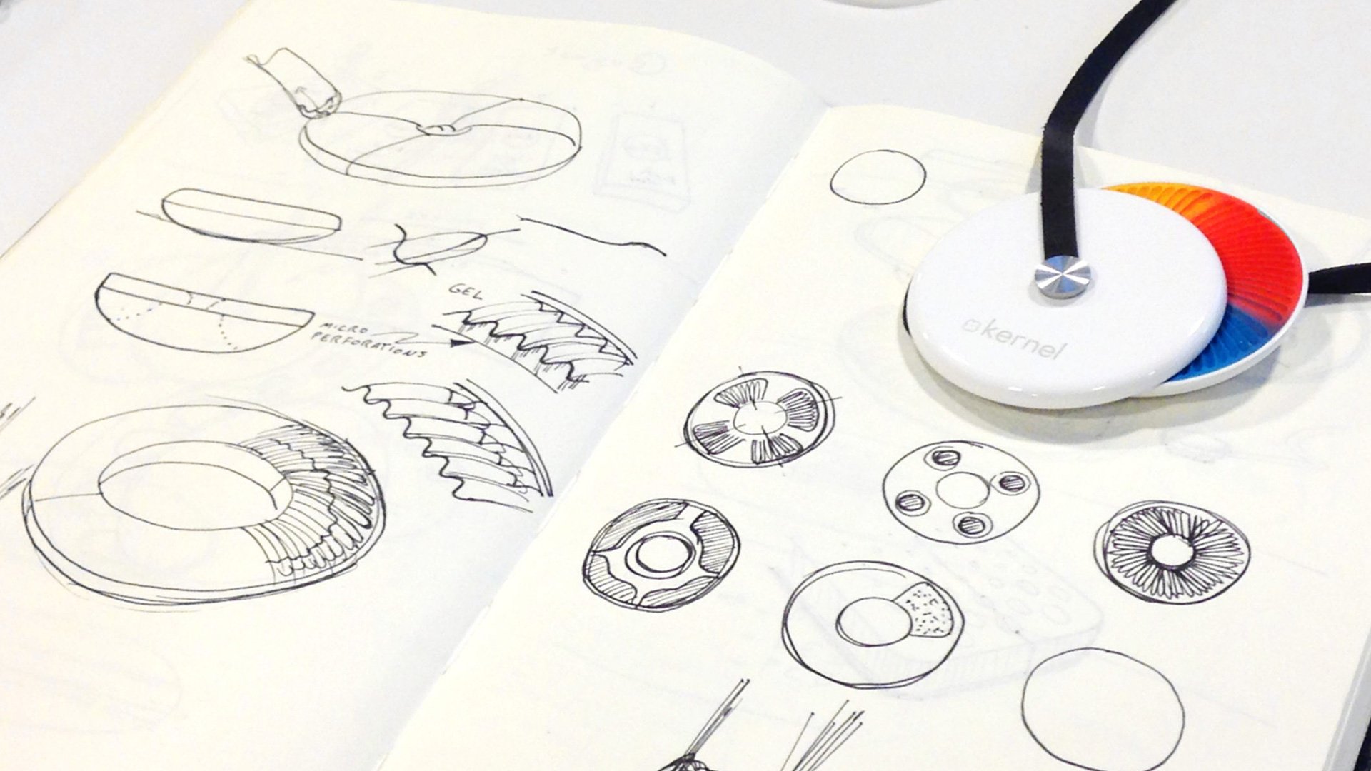Kernel design sketchbook open to show hand-drawn technical sketches, gear diagrams and concept drawings