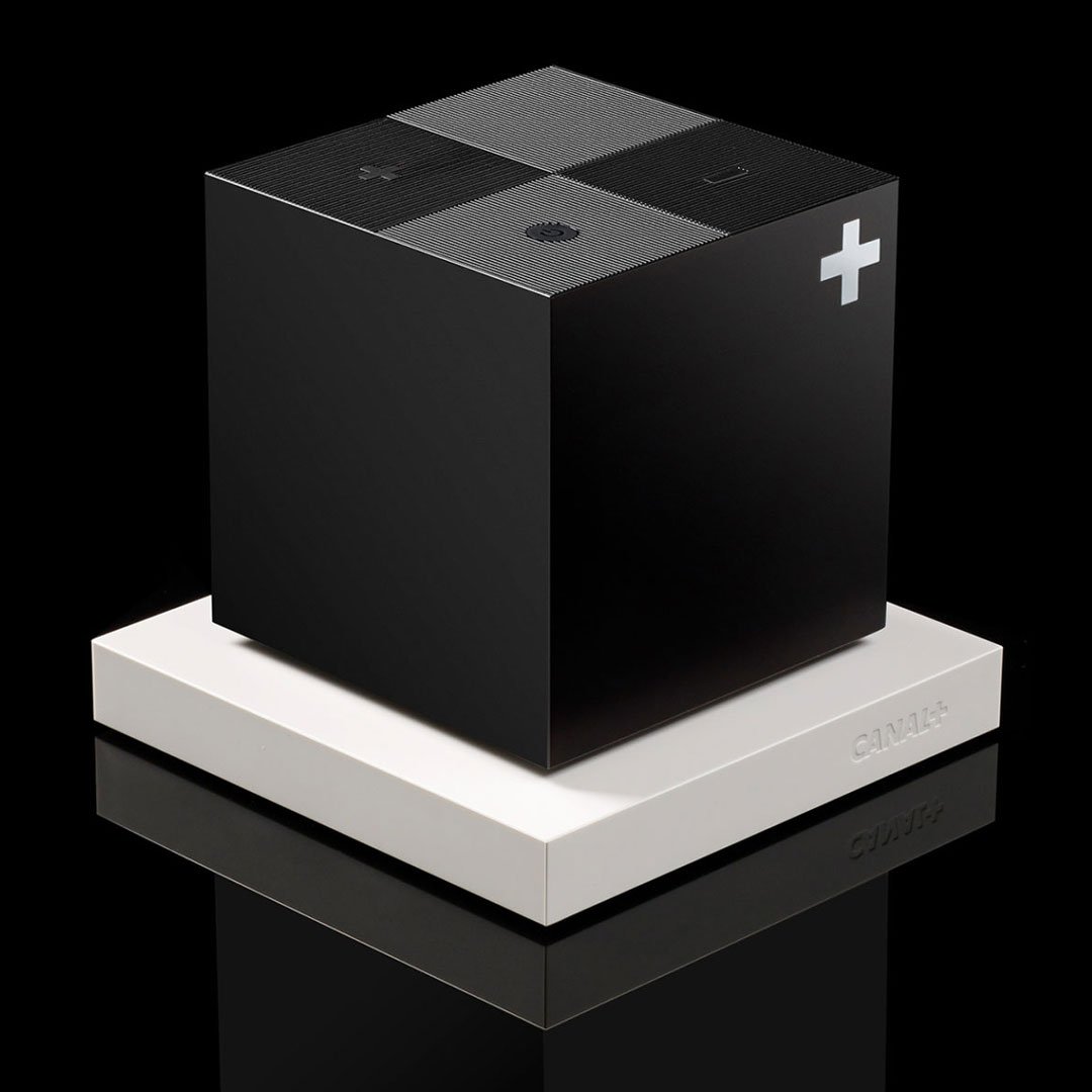 Black and white speaker on a white pedestal