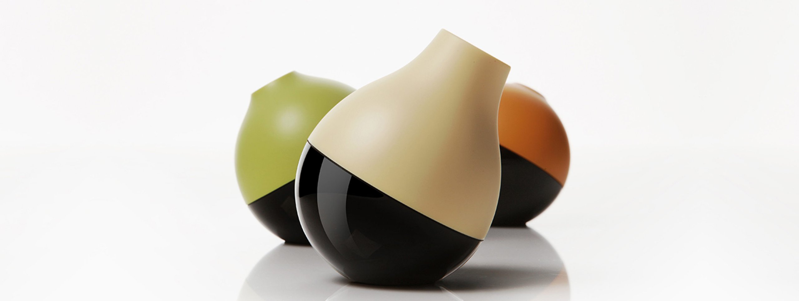 Three colored balls in a triangular formation on a reflective surface
