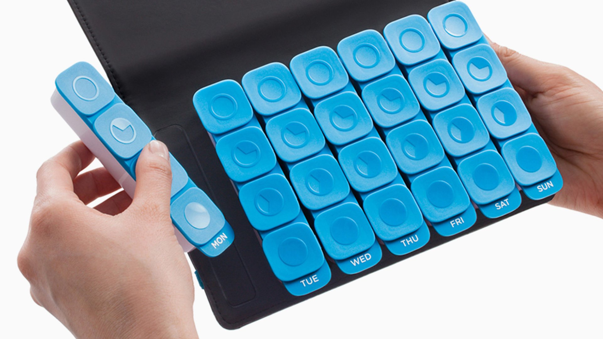 Person playing blue keyboard on a white background