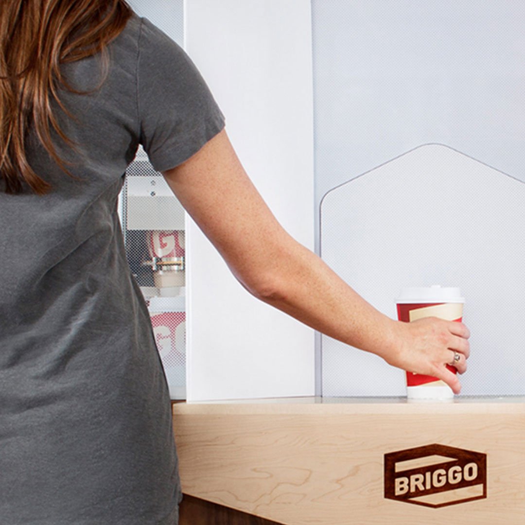 Customer using Biggo coffee touchscreen interface