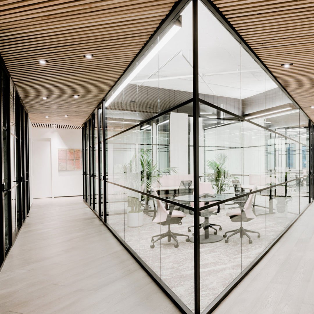 Canopy coworking glass walls and wood paneled interior
