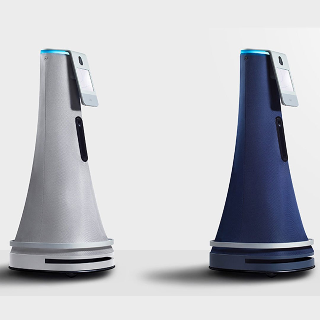 Three robotic vacuum cleaners in different colors on a plain background
