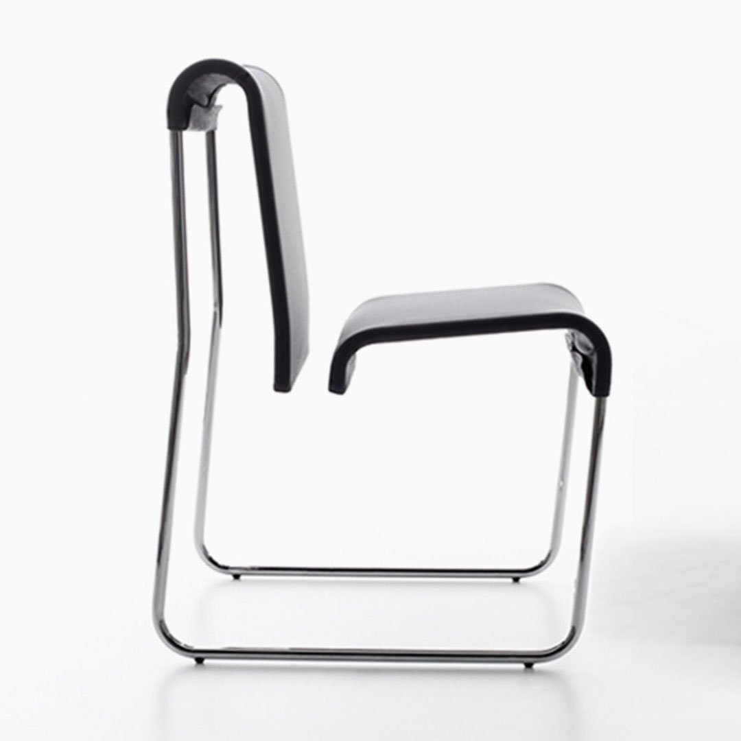 Black chair with white seat cushion on plain background