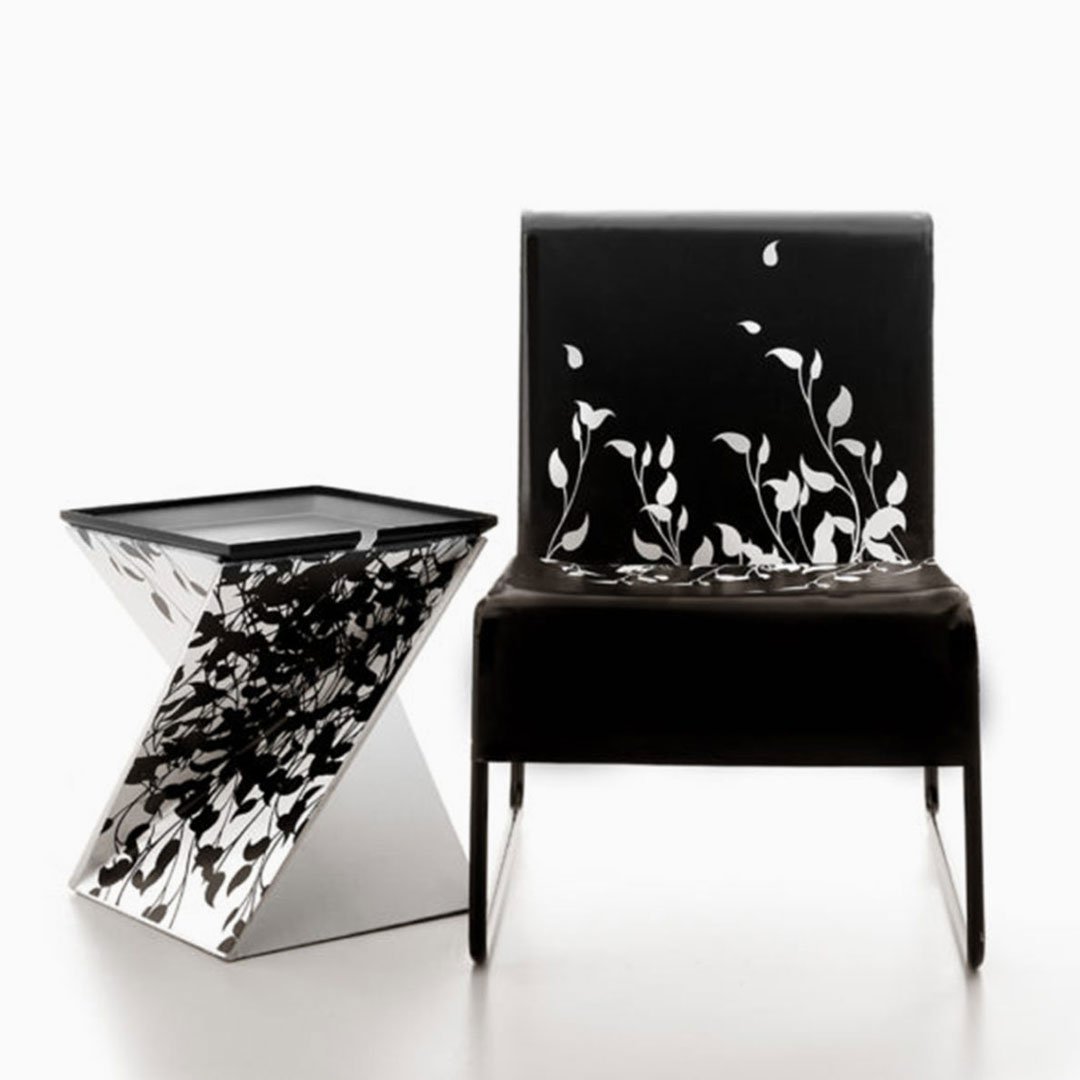 Black leather armchair with floral pattern and matching side table