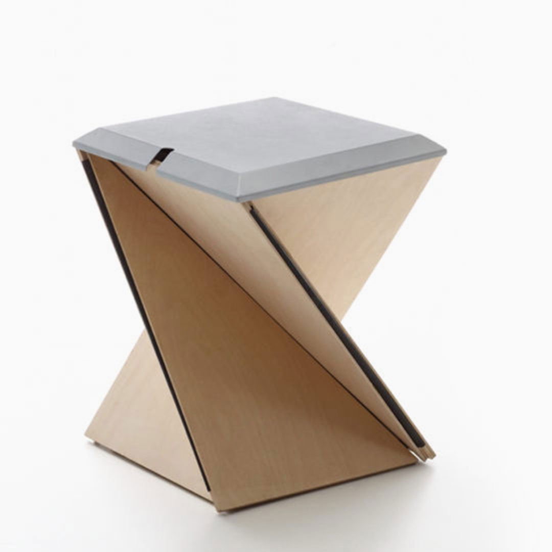 Danese Farallon stool by Yves Béhar, a sculptural folded plywood stool with origami-like twisted profile and a flat gray top
