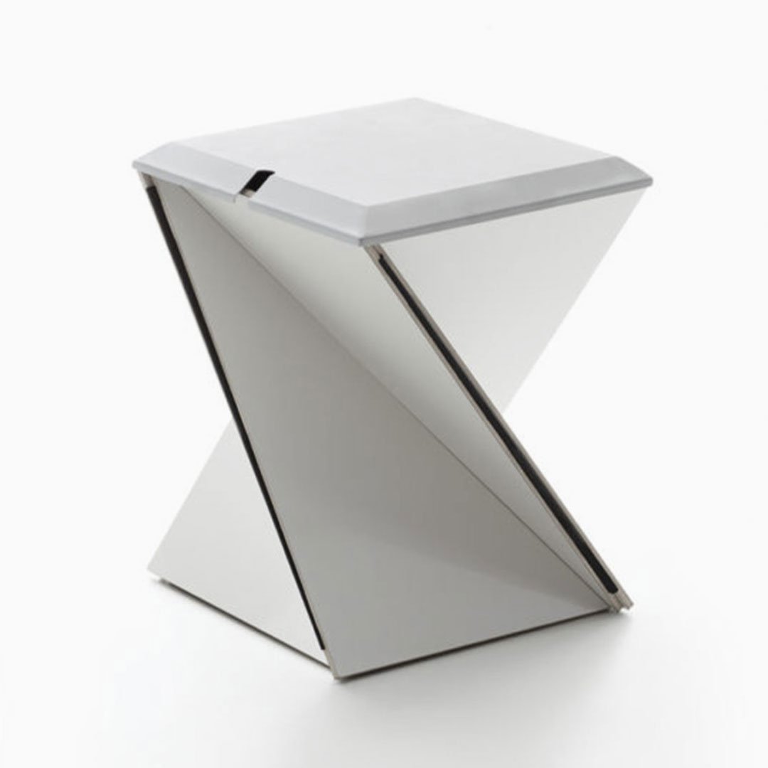 White stool with metallic silver frame on plain background