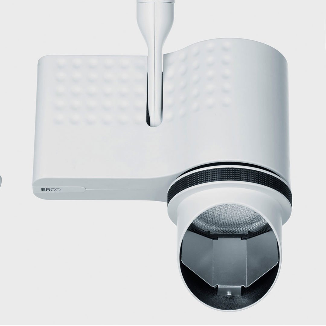 White security camera with black lens and green light