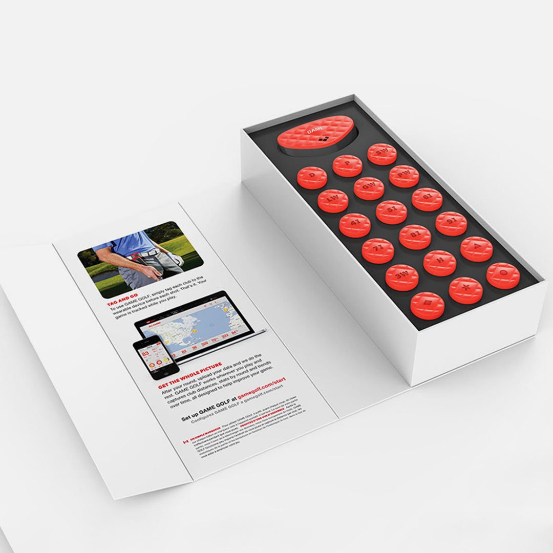 Red golf balls and pamphlet in open box