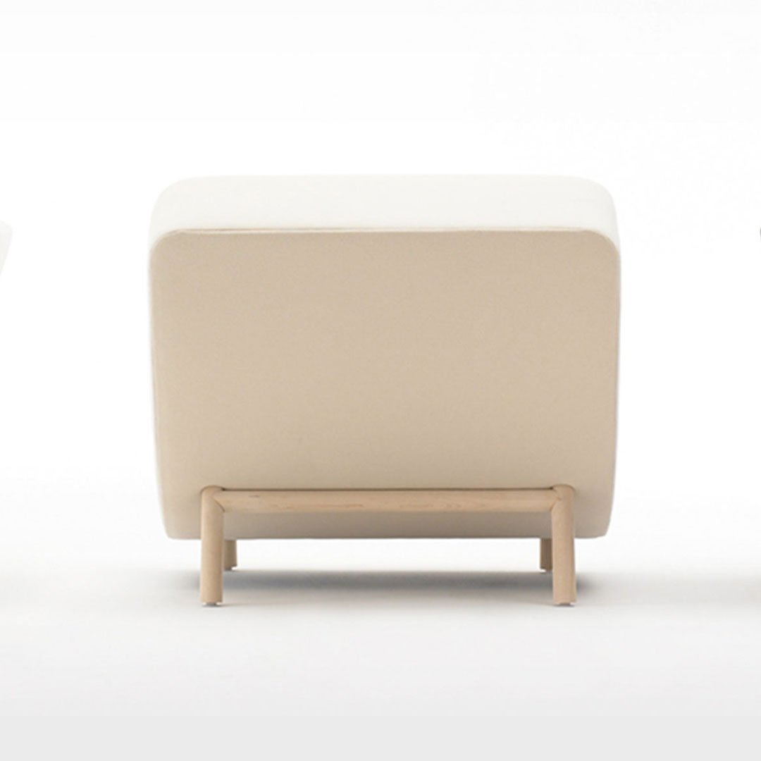 Light brown cushioned ottoman on a white background