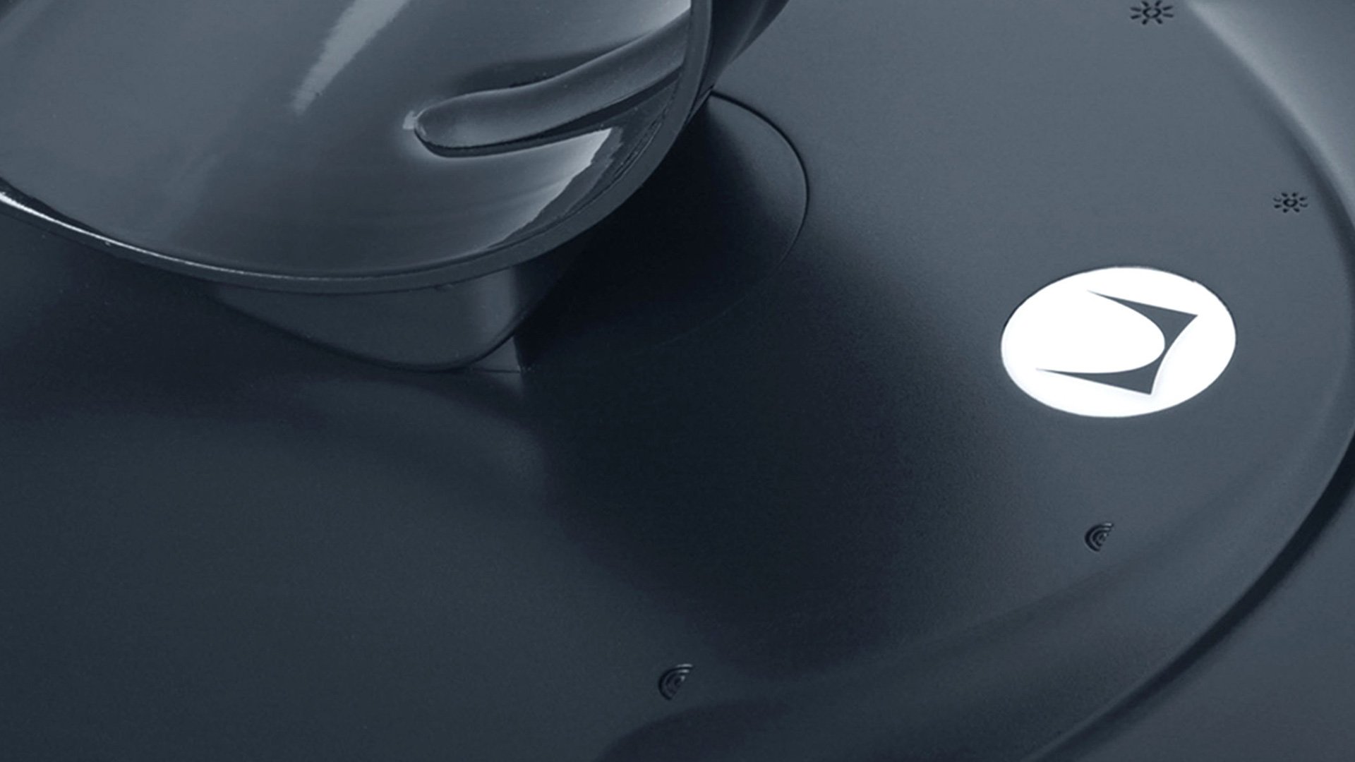 Herman Miller Leaf Lamp black base detail with white logo and engraved sound wave pattern