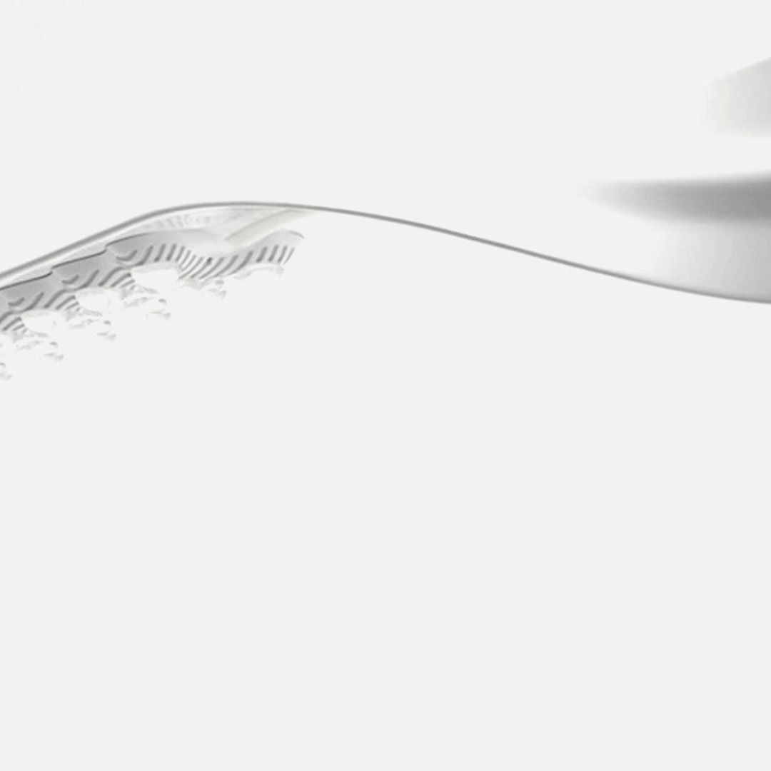Metal spoon with wavy handle on a white background