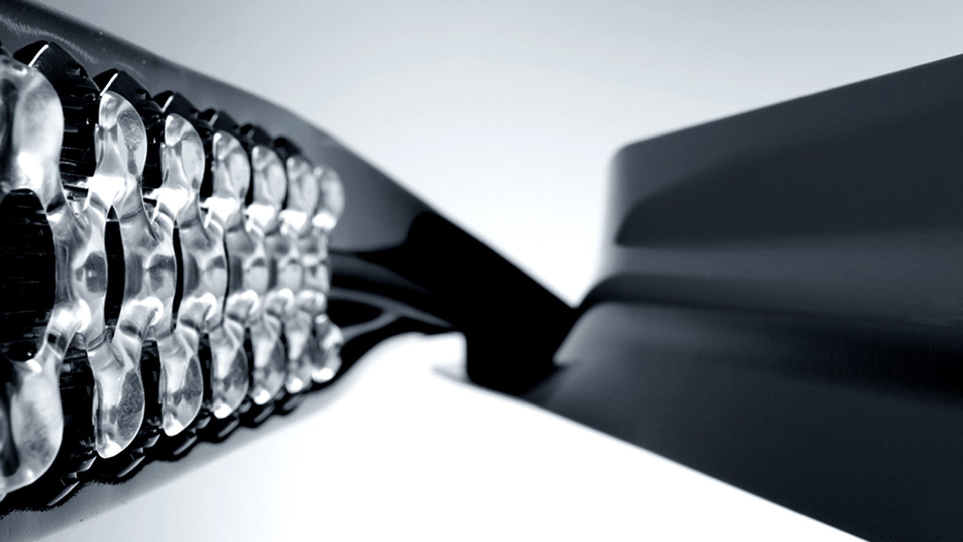 Herman Miller Leaf Lamp close-up showing reflective metallic cylindrical shade with patterned cutouts