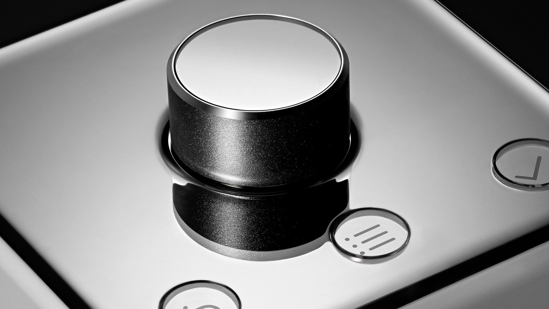 Small metallic object on a reflective surface with blurred indoor background
