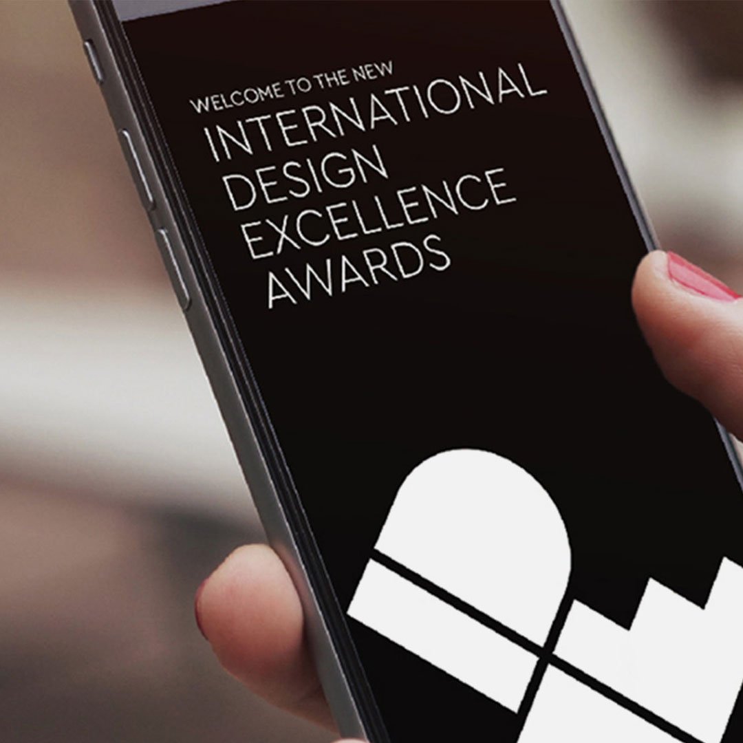 IDSA New IDEA invitation card displayed on a smartphone with red heart symbol on black and white background