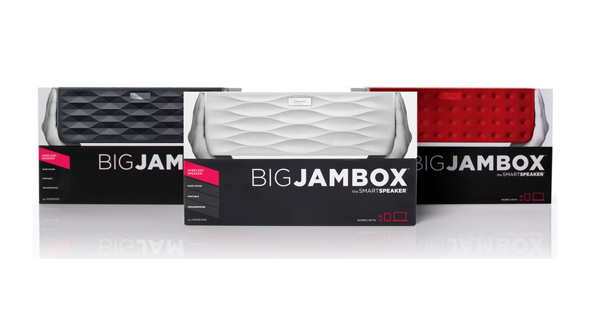 Three Big Jambox retail boxes lined up showing graphite, white and red color variants of the wireless Smart Speaker by Jawbon