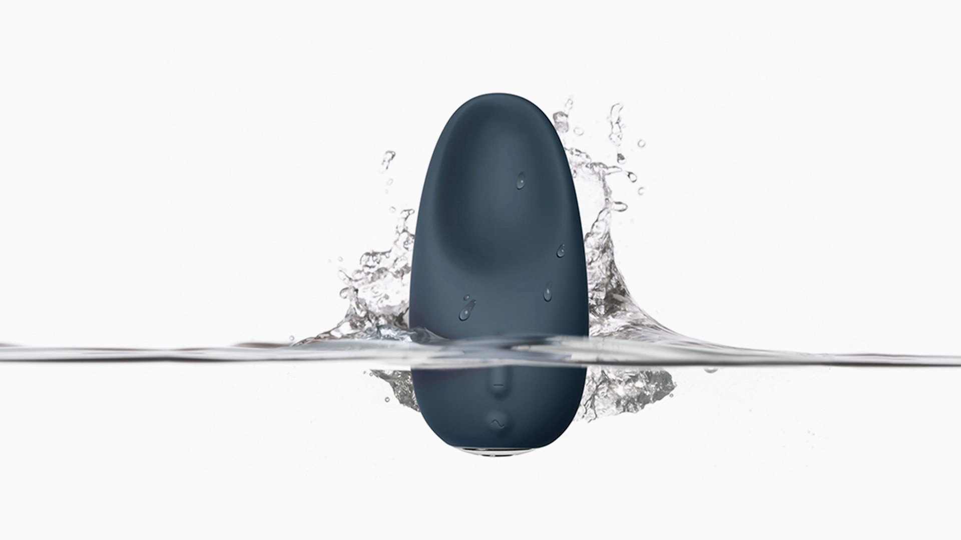 Jimmy Jane waterproof product suspended mid-air with water droplets on white background