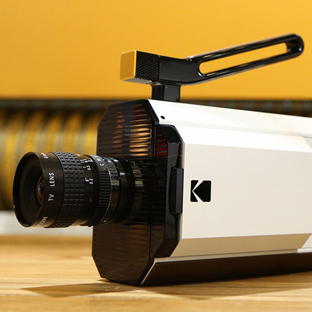 White and black camera with Kodak brand on it, large lens attached