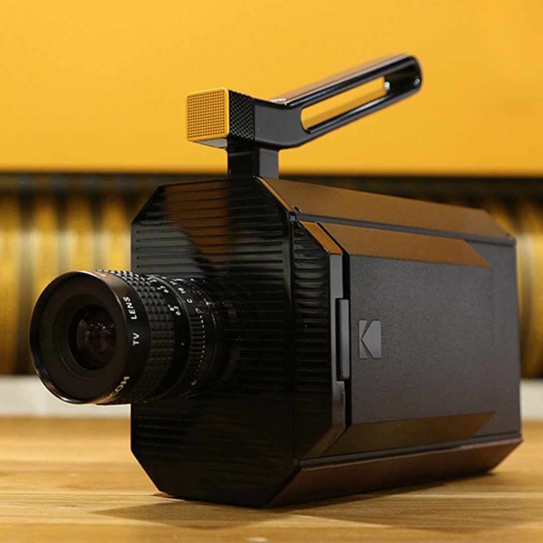 Black camera with lens on a table surface
