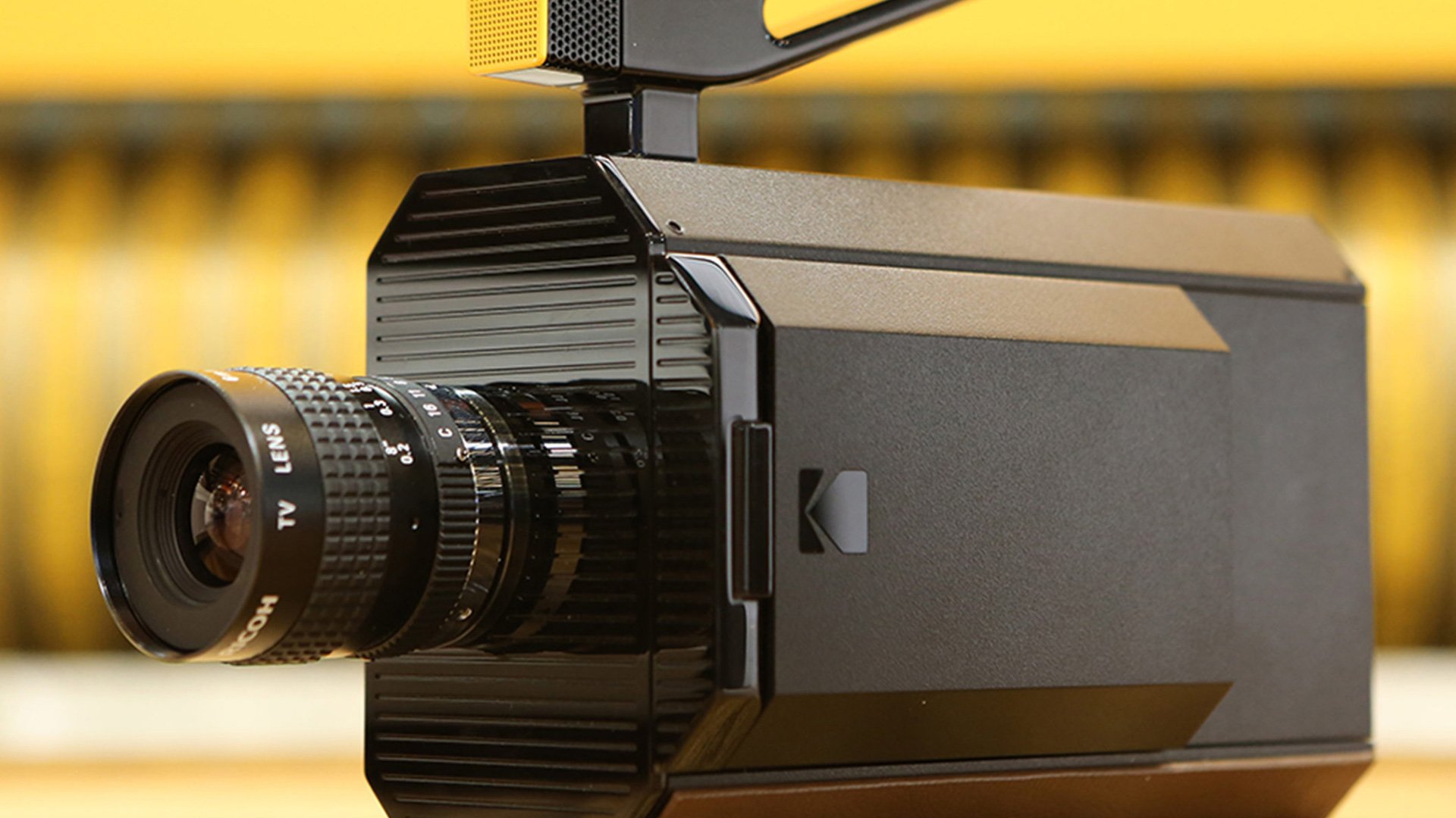 Black video camera with lens and brand logo on a surface