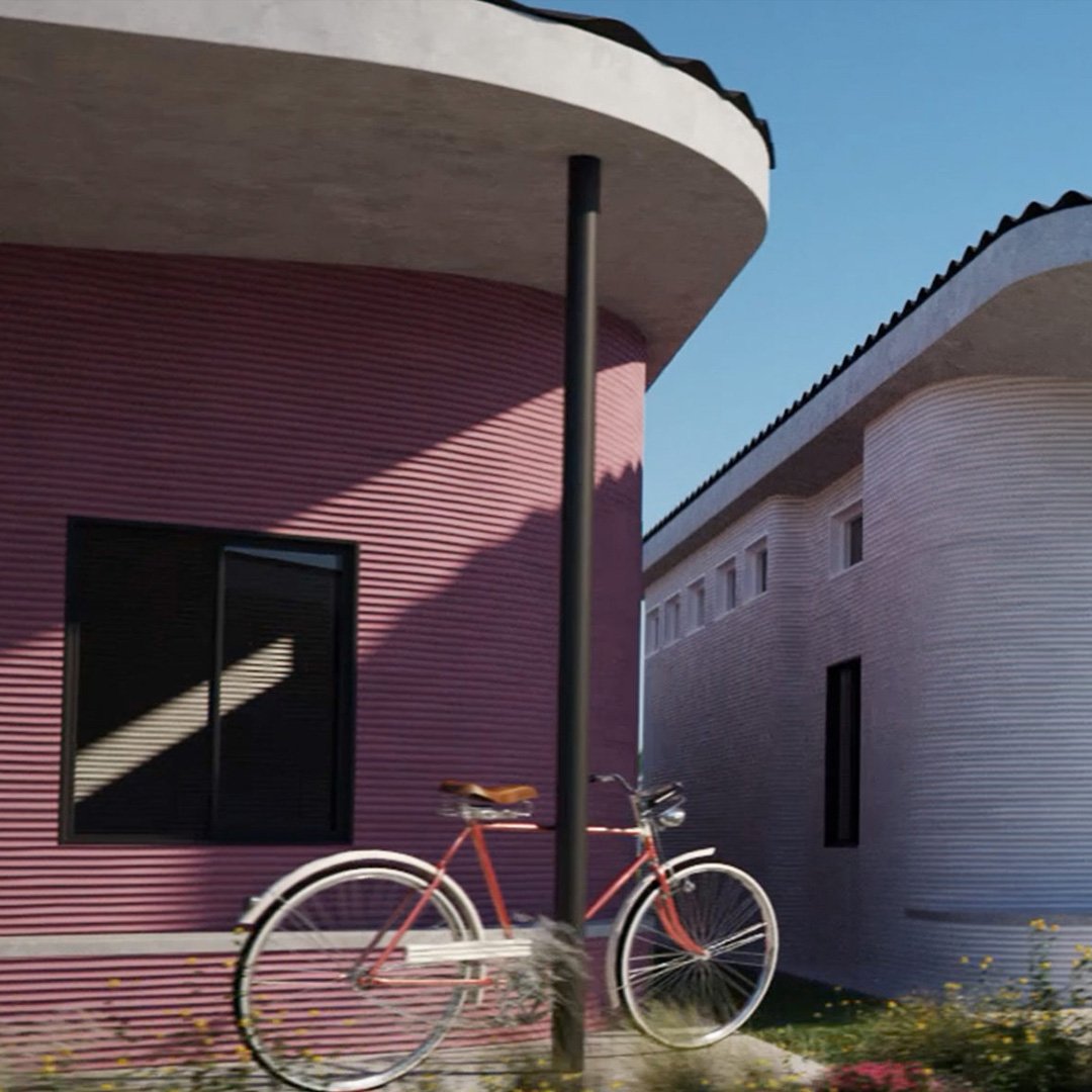 Pink house with curved roof and red bicycle parked outside