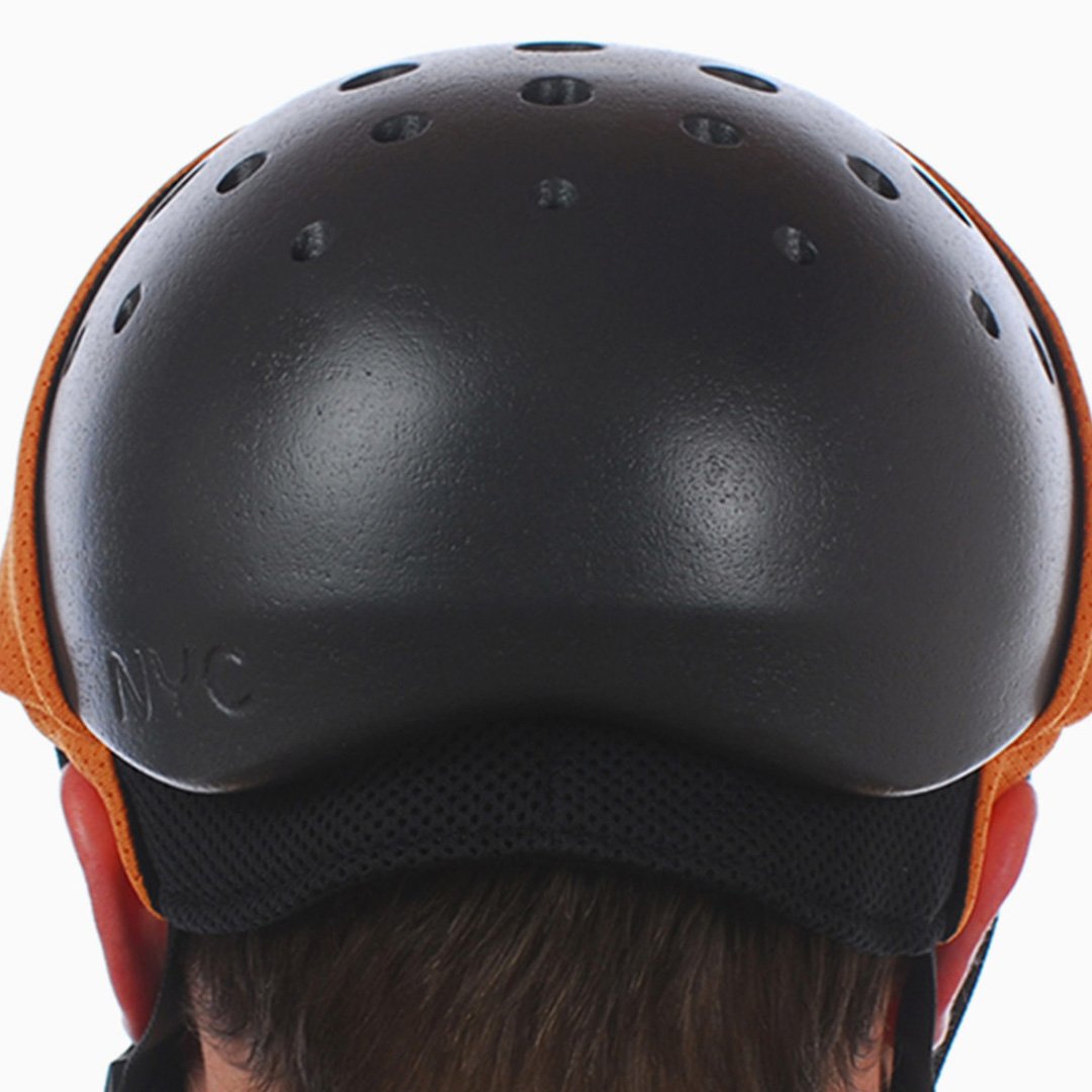 NYC Helmet design back view: black bicycle helmet with orange ventilation accent on the head of a wearer