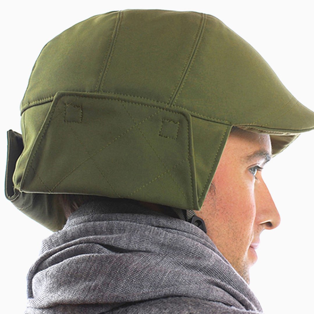NYC Helmet military-style green tactical helmet with visor and ear protection on a wearer