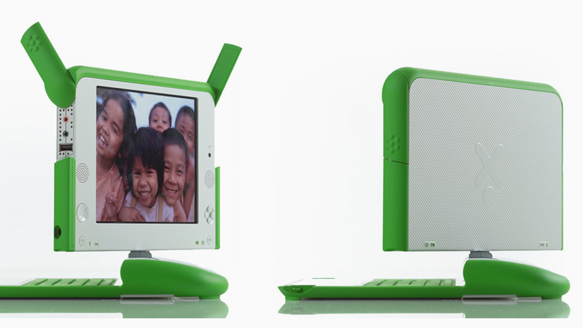 Green and white laptop with detached keyboard on plain background