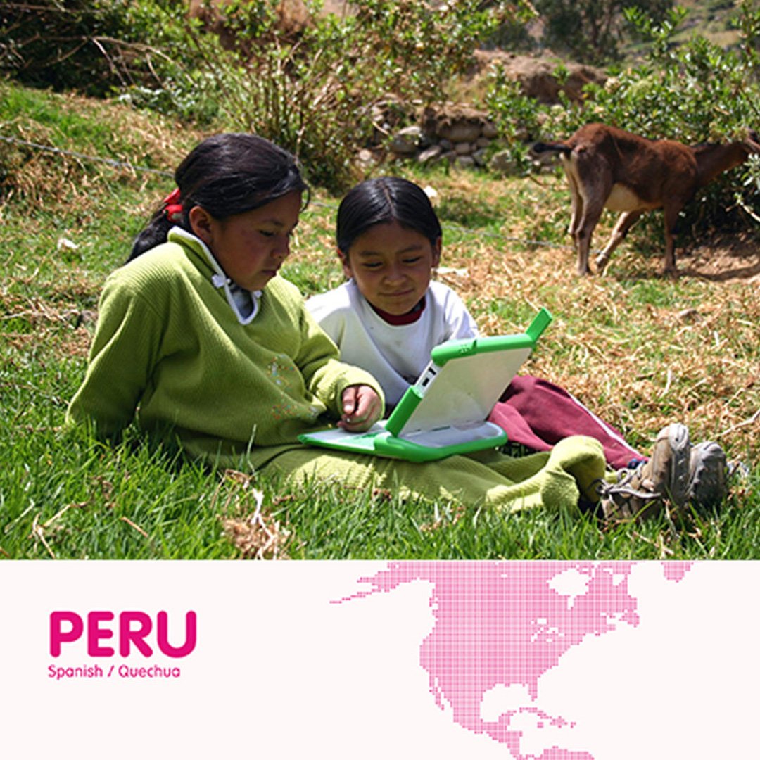 OLPC XO Laptop in Peru: two children using the green laptop outdoors with an adult in a rural setting