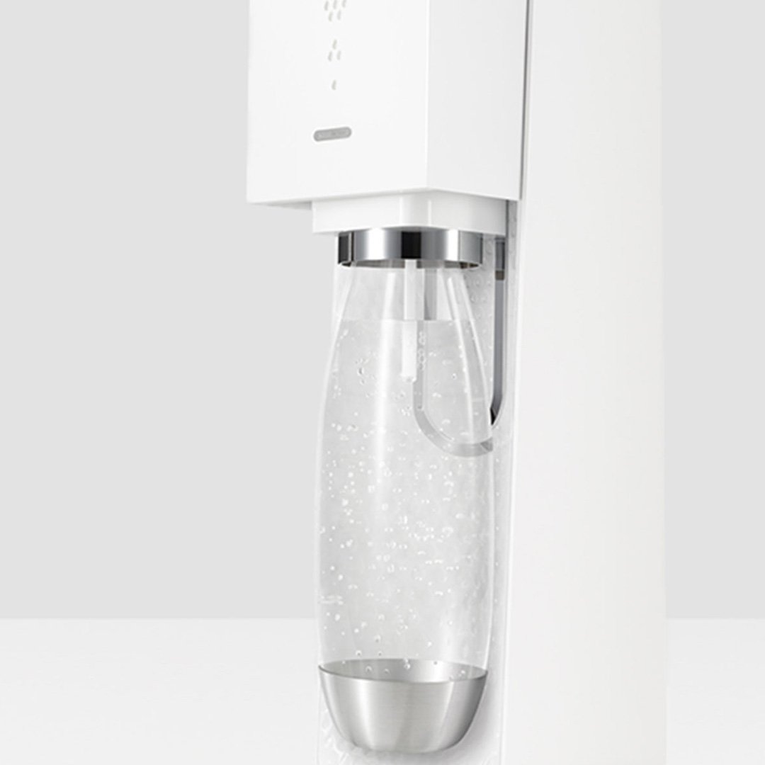 White kitchen appliance with glass jar and silver spout